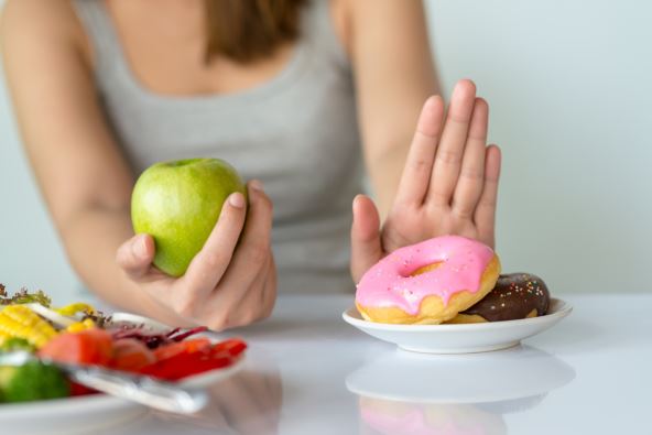 tridesete--stockphotodietingorgoodhealthconceptyoungwomanrejectingjunkfoodorunhealthyfoodsuchasdonutor1050601700.jpg