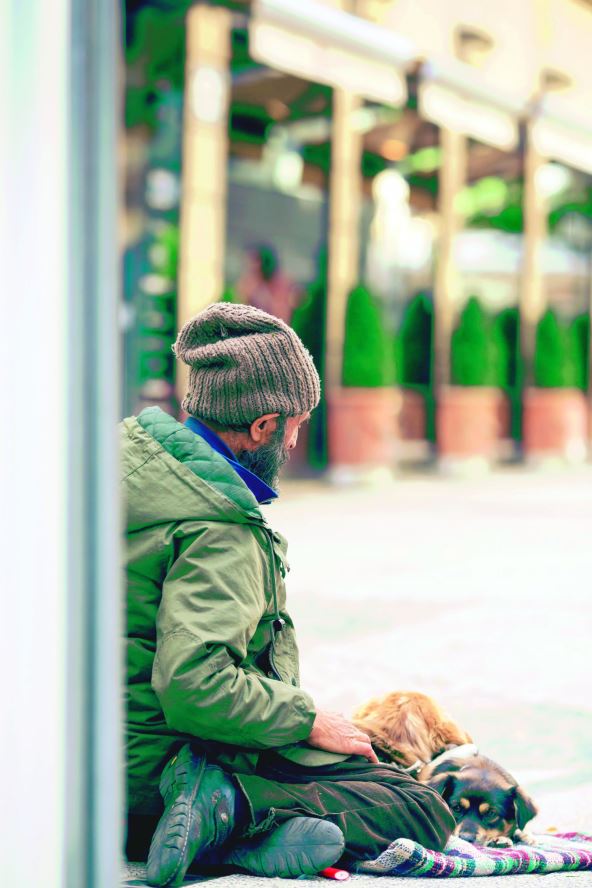 stockphotoahomelessguyissittinginthegroundwithadoginhisfeetheisbeggingformoneyinthe330216860.jpg