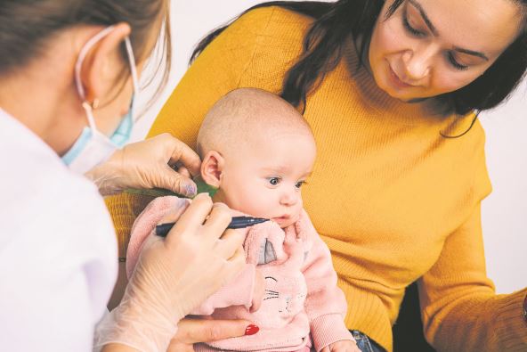 stockphotoenlargedphotoofalittlebabygirlwhosedoctorpointtheplaceformedicalearringsearpiercing1893634120.jpg