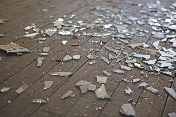 stockphotopiecesofshatteredglassormirrorinanabandonedhouse720164359.jpg