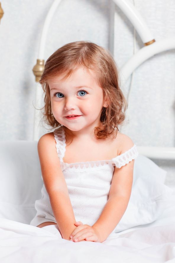 stockphotosweetcurlygirlsitinbed114065890.jpg