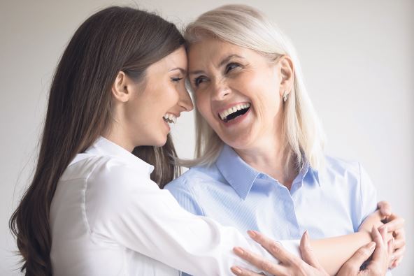 stockphotohappyexcitedseniormomandgrownupdaughterhavingfuntogetheryounggranddaughterlaughing2009960276.jpg
