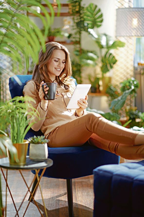 glavna--stockphotogreenhomesmilingtrendyhousewifewithlongwavyhairwithcupofcoffeeinbeigepantsand2053788287.jpg