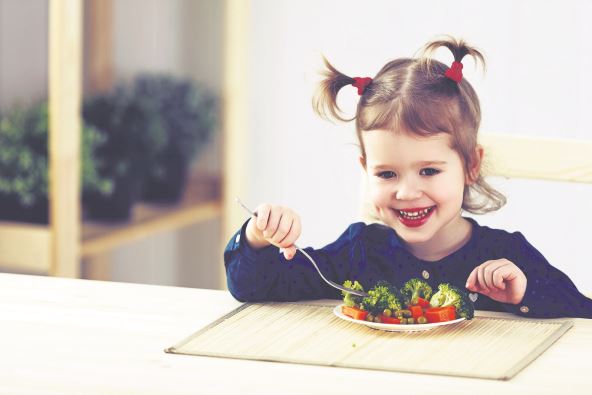 stockphotothehappychildgirleatingvegetablesandlaughs378055066.jpg