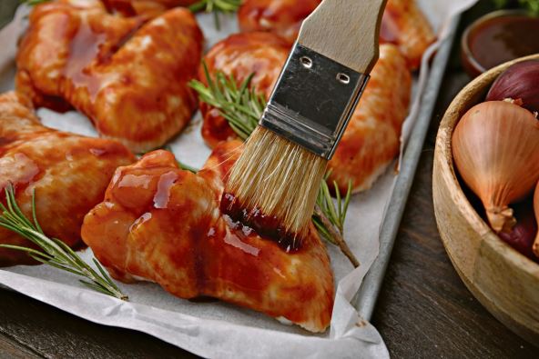 16--stockphotospreadingmarinadeontorawmarinatedchickenwingswithbastingbrushatwoodentablecloseup2450336613.jpg