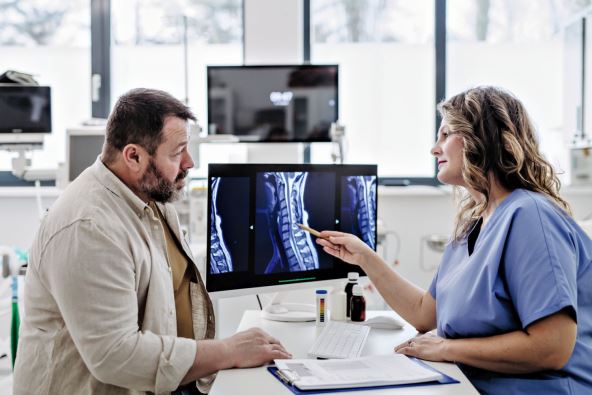 stockphotodoctorconsultingwithoverweightpatientdiscussingtestresultandxrayscansindoctoroffice2418718831.jpg