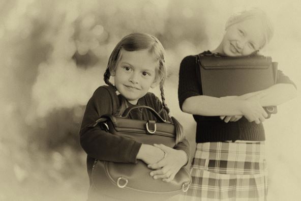 stockphotoadorableoldfashionedhappylittleyearsoldandyearsoldgirlsbacktoschoolconcept726665173.jpg
