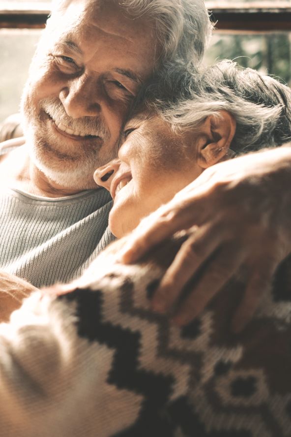 stockphotooldseniorcoupleinlovehugandembracewithromancetogetherathomewithoutsideviewin2412861199.jpg