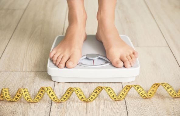 MRSAVITE POLAKO  stock-photo-young-woman-measuring-her-weight-at-home-1894421233.jpg