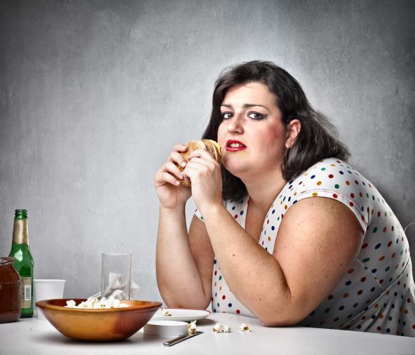 stock-photo-fat-woman-feeling-guilty-while-eating-junk-food-79925764.jpg