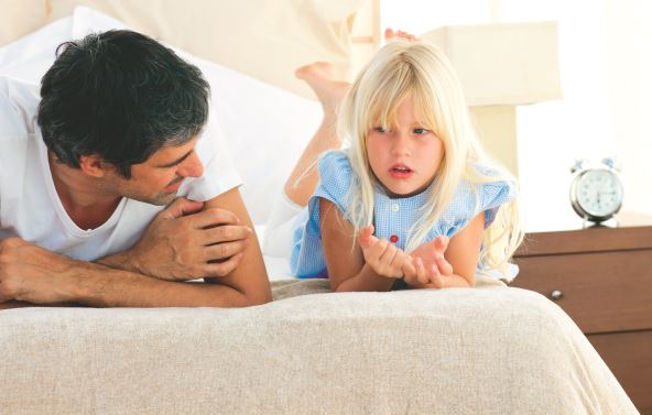 stock-photo-little-girl-talking-seriously-with-her-father-lying-on-bed-46375792.jpg