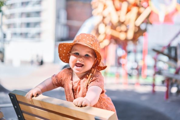 stock-photo-portraits-of-a-cute-months-old-baby-girl-walking-on-the-playground-on-a-sunny-summer-day-2305325247.jpg