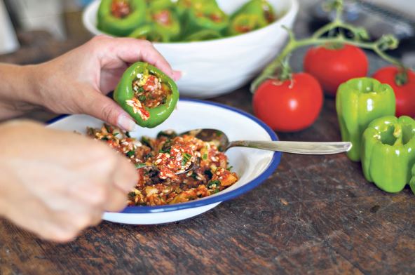 stock-photo-woman-is-filling-with-rice-and-meat-the-green-pepper-turkish-cuisine-food-the-stuffed-pepper-1480462343.jpg