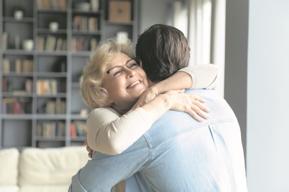 NE DOZVOLITE DA SE OSECA USAMLJENO  stock-photo-close-up-smiling-mature-woman-wearing-glasses-hugging-adult-son-standing-in-living-room-at-home-1857044374.jpg