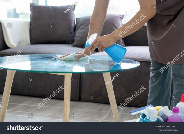 STAKLENI STO  stock-photo-female-housekeeper-wearing-apron-and-casual-clothes-standing-at-table-with-buckets-of-cleaning-2375747517.jpg