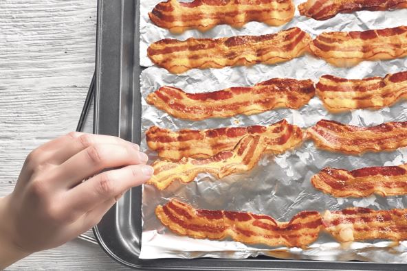 9   stock-photo-female-hand-checking-strips-of-fried-bacon-on-baking-tray-620341214.jpg