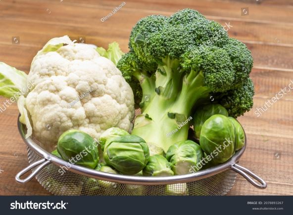 stock-photo-cauliflower-brussels-sprouts-and-broccoli-in-colander-wooden-background-top-view-2078893267.jpg