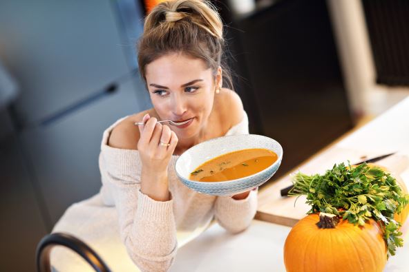 stock-photo-picture-of-adult-woman-tasting-pumpkin-soup-in-the-kitchen-1192542316.jpg