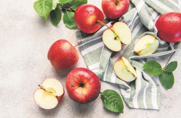 stock-photo-red-apples-and-apple-halves-with-leaves-on-a-striped-green-and-white-cloth-2684296303.jpg