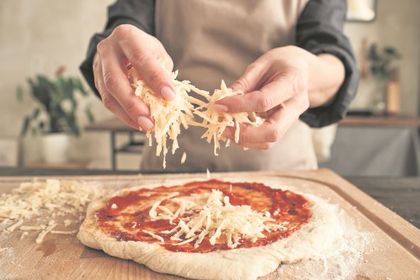 STAVLJATE PREVISE SIRA  stock-photo-close-up-of-unrecognizable-woman-standing-at-wooden-board-and-sprinkling-cheese-on-pizza-dough-with-2139307249.jpg