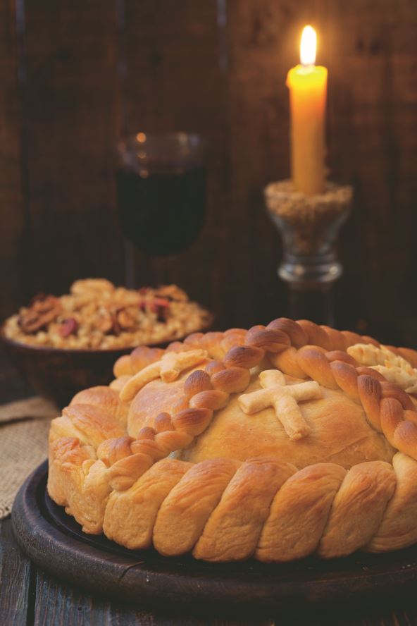 stock-photo-serbian-slava-cake-with-wheat-and-candle-slavski-kola-decorative-bread-for-traditional-2090302732.jpg