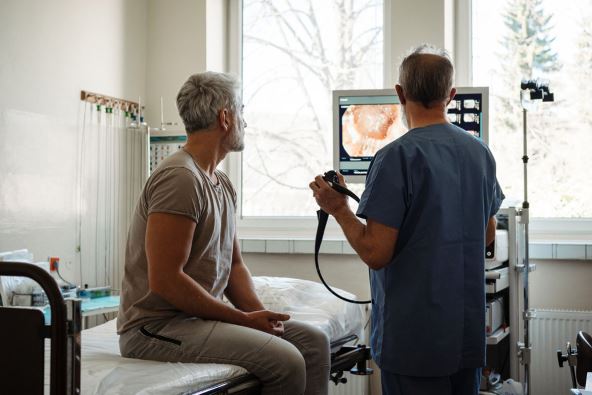stock-photo-doctor-explaining-colonoscopy-results-to-patient-using-monitor-images-2633403851.jpg