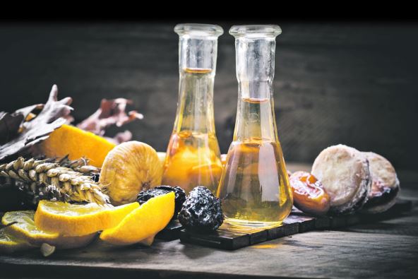 stock-photo-traditional-plum-brandy-in-the-traditional-shot-glass-with-dried-fruits-on-wooden-background-550202497.jpg