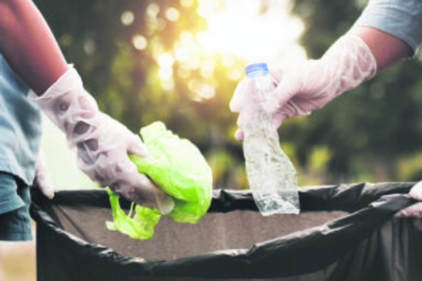 stock-photo-woman-hand-picking-up-garbage-plastic-for-cleaning-at-park-1342068971.jpg