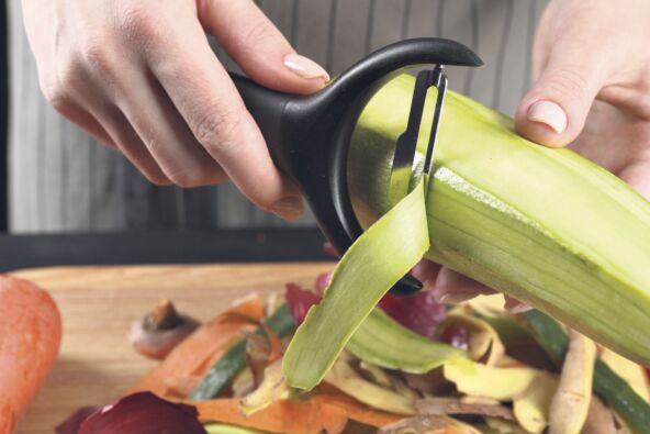 stock-photo-woman-peeling-fresh-zucchini-at-table-closeup-2433324745.jpg