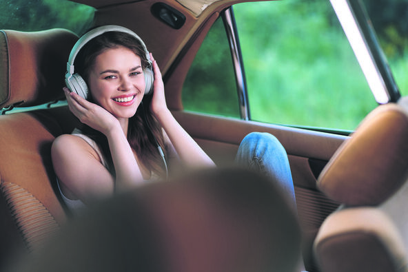 ANTR   stock-photo-young-woman-enjoying-music-in-a-car-with-headphones-smiling-joyfully-in-a-relaxed-setting-amidst-2624660435.jpg