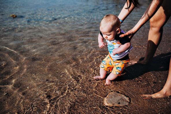 PRVO KUPANJE  stock-photo-young-mother-for-the-first-time-for-a-young-boy-shows-sand-on-the-beach-the-sea-and-gives-a-try-to-1343492729.jpg
