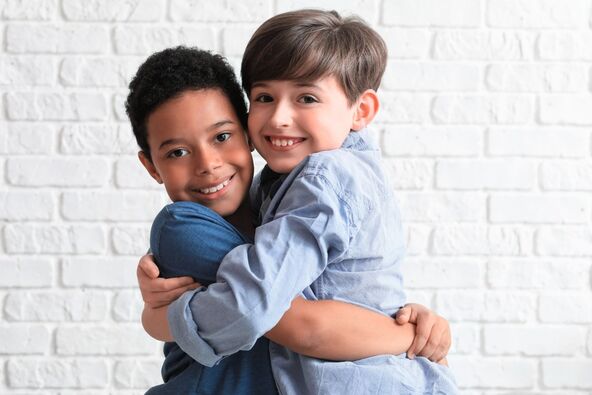 SVI SU LJUDI RAZLICITI   stock-photo-cute-little-boys-hugging-near-white-brick-wall-closeup-2324496543.jpg