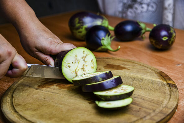 PATLIDZAN  stock-photo-woman-cutting-eggplant-on-a-cutting-board-2396688017.jpg