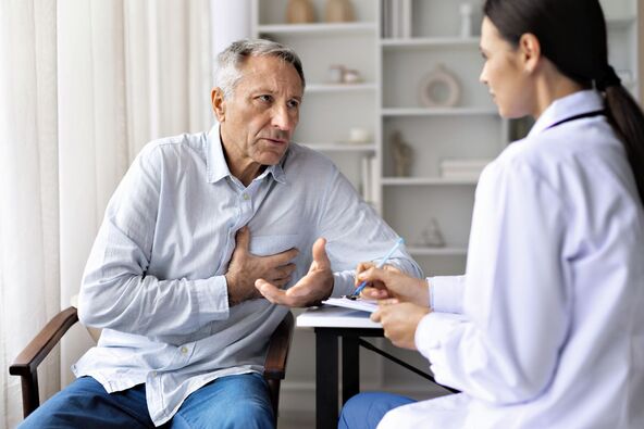stock-photo-senior-male-patient-describing-chest-discomfort-to-female-doctor-during-medical-consultation-2728378493.jpg