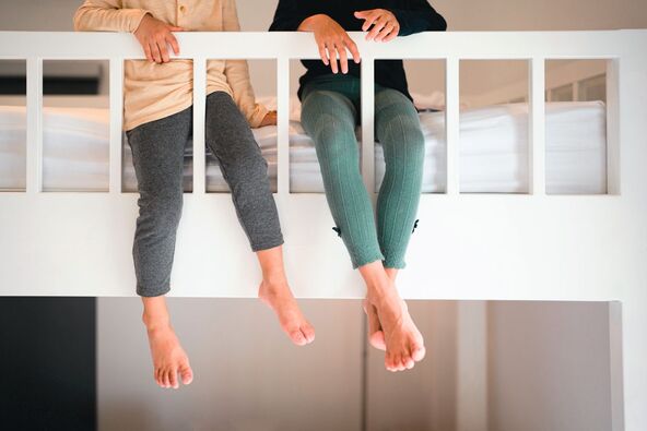 stock-photo-unidentified-two-sibling-kid-s-leg-and-feet-are-sitting-on-the-bunk-bed-concept-of-friedship-love-2175439937.jpg