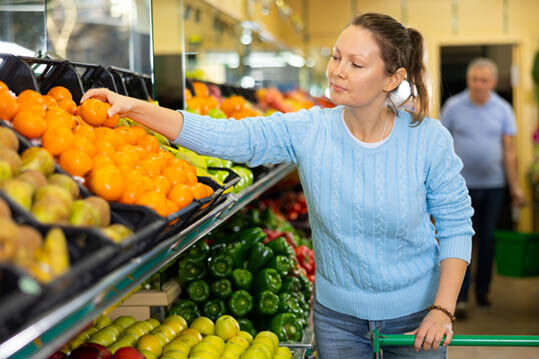 stock-photo-glad-middle-aged-woman-customer-buying-fresh-mandarins-at-the-counter-in-big-greengrocery-2823174439.jpg