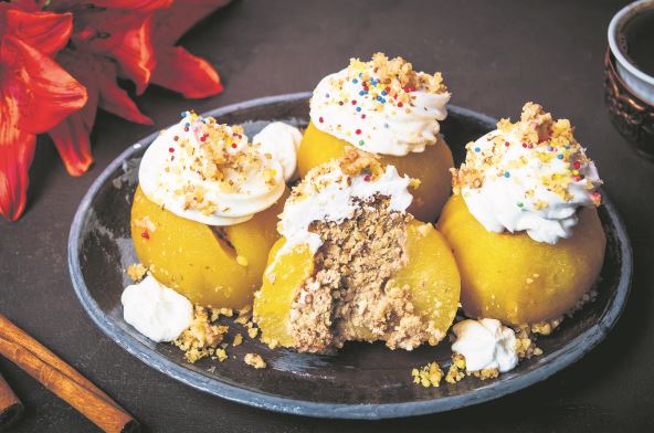 stockphotopoachedapplewithwhippedcreamandwalnutsonaplate1697876668.jpg